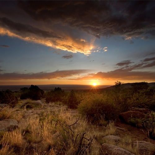A majestic sunset over the Chihuahuan Desert at the base of the Sandia Mountains, outside of Albuquerque, New Mexico